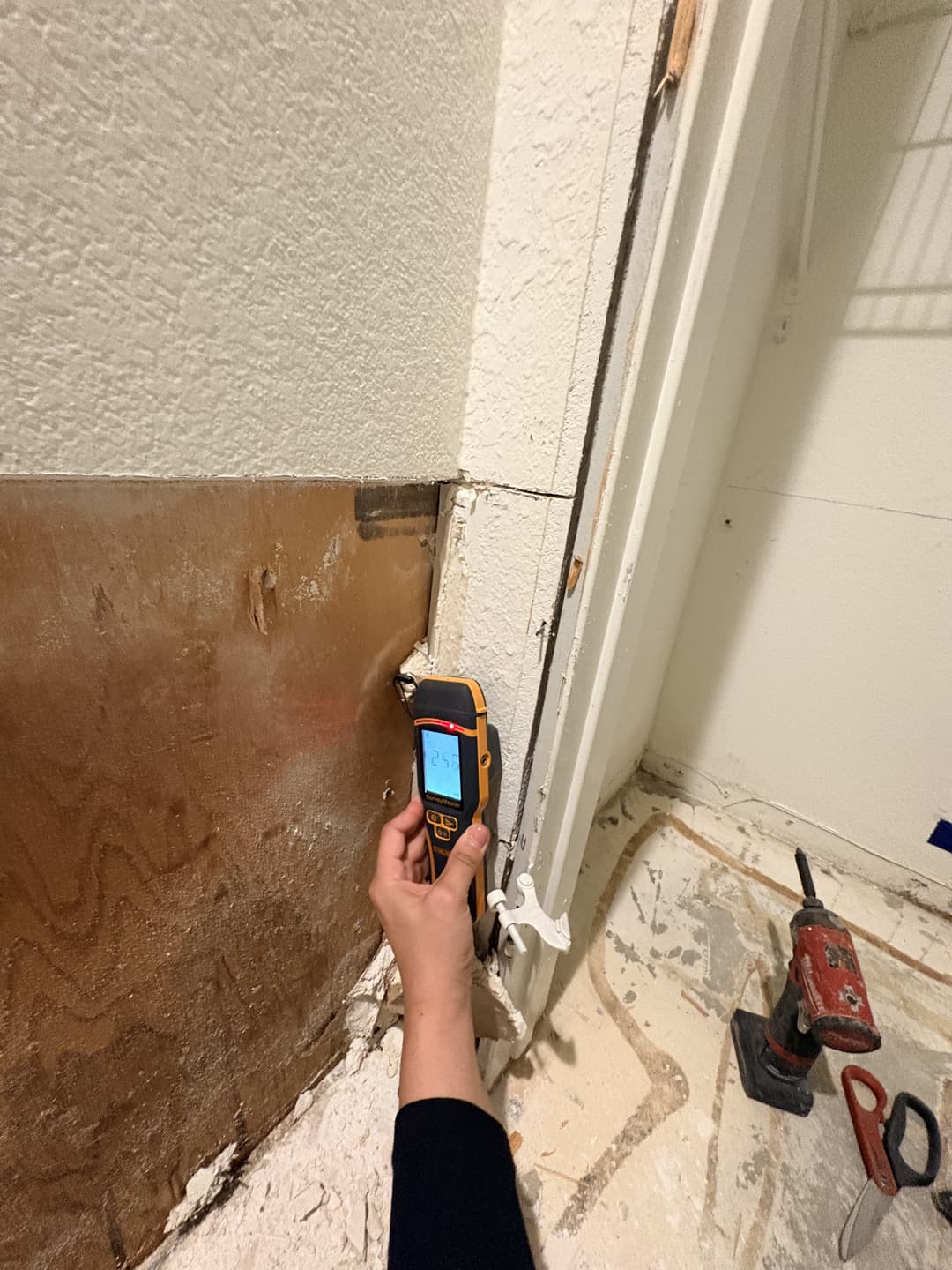 Bathroom with flood cuts visible on lower walls showing exposed framing and plumbing after water damage in Anaheim